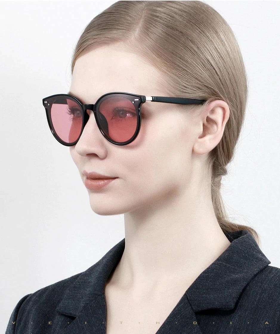 Female model wearing photochromic red lens Veithdia Women's Round-Frame sunglasses