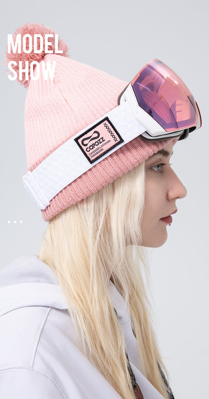 Female model wearing sakura pink Copozz Aurora Ski goggles